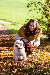 Girl with a poodle in forest