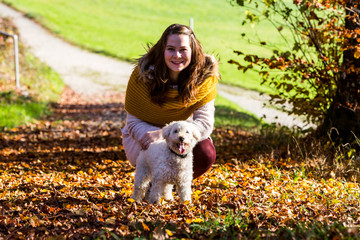 Girl with a poodle in forest