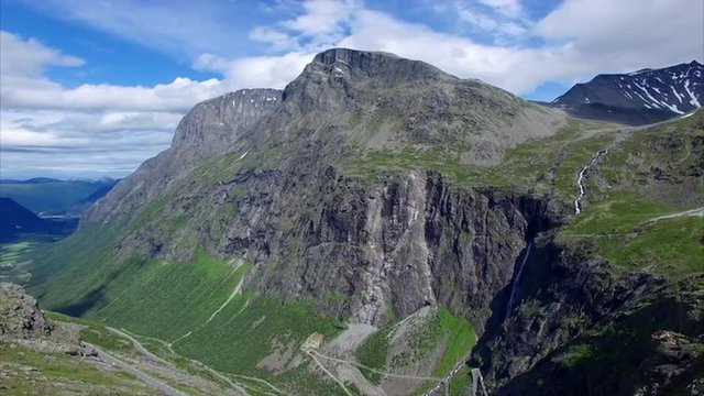 Trollstigen mountain pass in Norway on sunny summer day, one of the most beautiful roads in the world, major tourist attraction. Aerial 4k Ultra HD.
