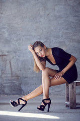 Obraz na płótnie Canvas Sexy young female in black short dress.