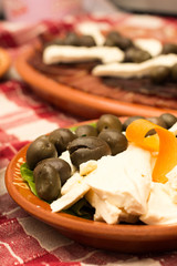 Cured meat with cheese and olives on the plate
