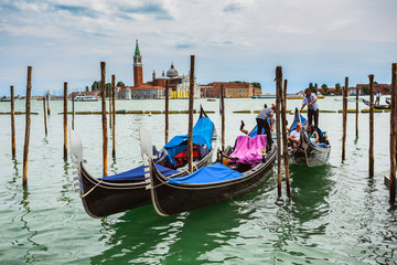 Fototapeta na wymiar Gondolas moored by Saint Mark square
