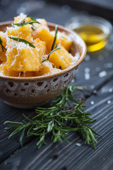 Crunchy croutons in bowl with rosemary