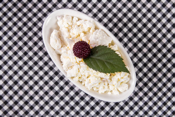 plate of fresh cottage cheese on tablecloth