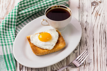 fried egg with toast on a plate
