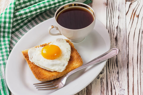 fried egg with toast on a plate