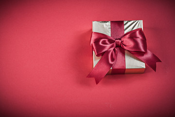Gift box on red background holidays concept