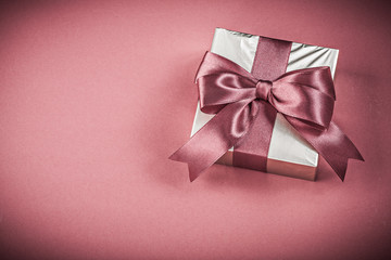Present box on red background holidays concept