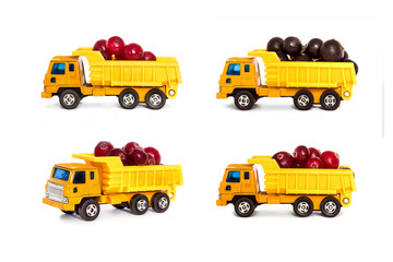 Toy dump trucks loaded with berries