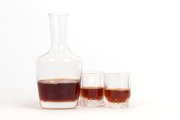 The decanter of brandy and glasses on a white background, meeting friends, alcohol dependence