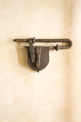 Antique padlock on adobe wall, Oaxaca, Mexico