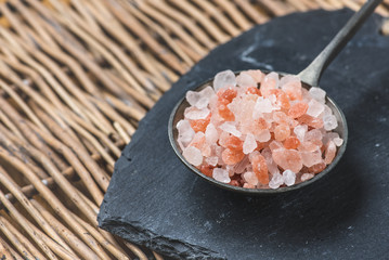 Himalaya salt on a tin spoon - slate plate