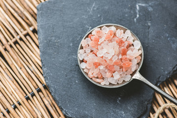 Himalaya salt on a tin spoon - slate plate