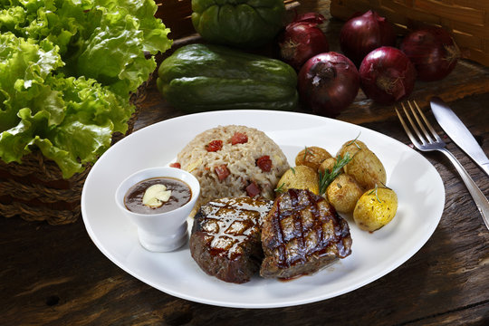 Grilled steak with potato and rice