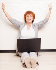 Woman sitting on floor with laptop