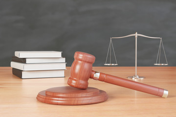 litigation inventory with gavel, books and scales on wooden tablе