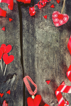 hearts and ribbons on wooden surface