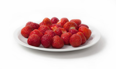 Heap of prepared strawberry on plate, isolated