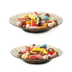 Glass plate full of candies isolated