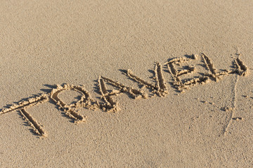 Inscription Travel on sandy beach