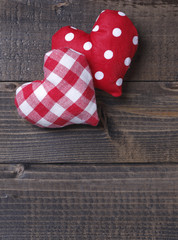 Country style handmade red heart pillows on wooden background