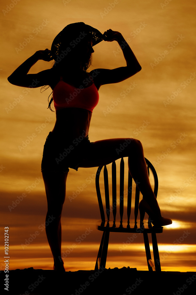 Canvas Prints Silhouette of cowgirl foot on chair hands on hat