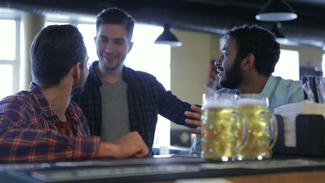 Group of happy young friends drinking beer
