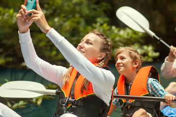 family kayaking and makes self