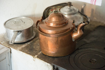 old-fashioned copper tea kettle on a stove