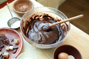 Preparing dough for chocolate pie on table close up