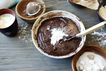 Preparing dough for chocolate pie on table close up