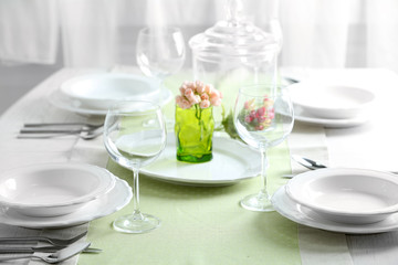 Table set at restaurant on light background