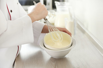 Cooking buttery cream on kitchen