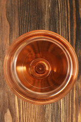 Glass of wine on wooden table. Top view