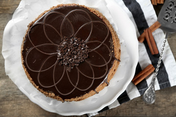 Tasty chocolate cake on wooden background
