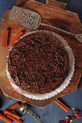 Tasty chocolate cake on color wooden background
