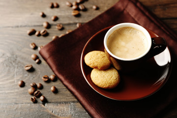 Cup of coffee on wooden table background