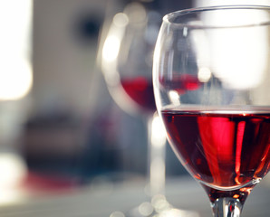 Glass of red wine on blurred background
