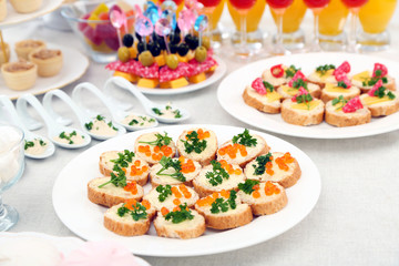 Set of cold snacks, canape, beverages, closeup