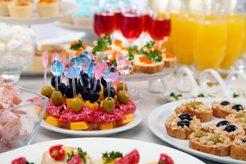 Set of cold snacks, canape, beverages, closeup