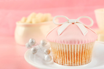 Tasty pink cupcake with decorations, closeup