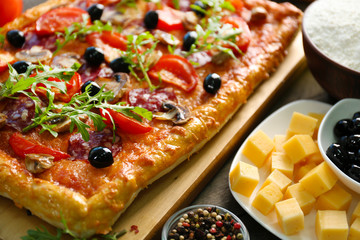 Rectangle delicious pizza and vegetables on the table