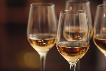 Glasses with white wine on blurred background