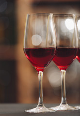 Glasses with red wine on blurred background