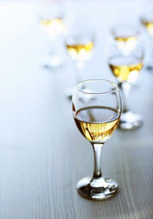 Glasses of wine on wooden blurred background