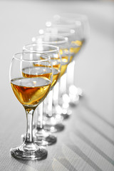 Row of wineglasses on wooden blurred background