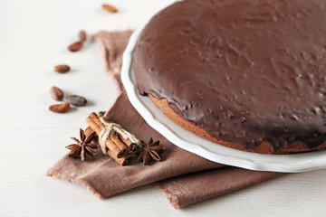 Tasty chocolate frosting cake on light table, close up
