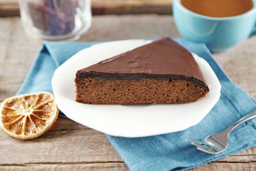 Piece of frosting chocolate cake on white plate