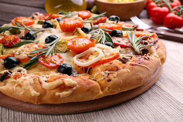 Delicious fresh pizza on wooden table closeup