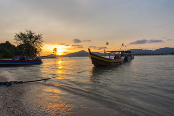 Obraz na płótnie Canvas Fisherman boat at the beach during sunset